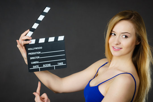 Woman holding professional film slate