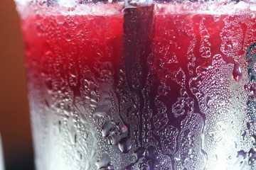 Chilled fruit juice in plastic cup scene.