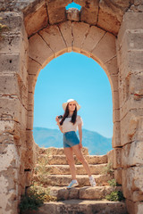 Fototapeta na wymiar Tourist Girl with Retro Camera in Medieval Castle Landmark 