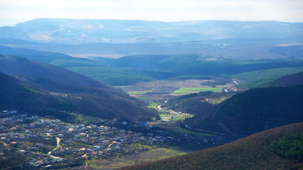 Obraz premium Village in valley among mountains