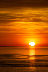 The sun setting in the pacific ocean in Washington State, USA