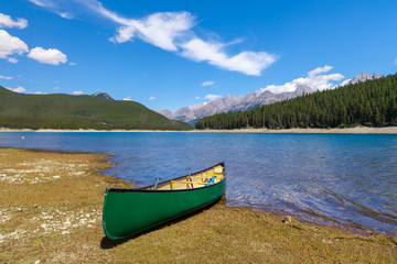 Green Canoe on the shore of a mountain lake, Peter Lougheed provincial Park, Alberta