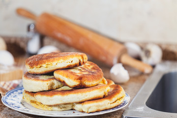 Plate with fried pies stands on marble table