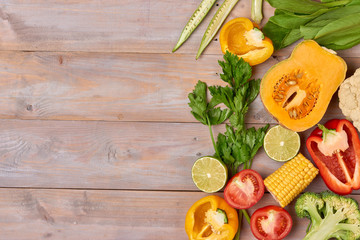 Assortment of the fresh vegetables on wooden background