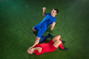 Naklejka premium Happy and unhappy football players after goal