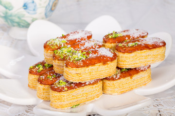 Group of Light Crunchy Puff Layered Pastry Garnished With Pistachios & Coconut Flakes Popular Persian Sweets In Iran Called Zaboon Or Zaban