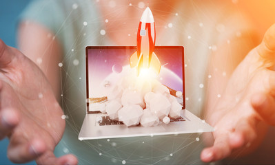 Businesswoman with rocket launching from a laptop 3D rendering