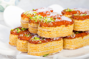 Group of Light Crunchy Puff Layered Pastry Garnished With Pistachios & Coconut Flakes Popular Persian Sweets In Iran Called Zaboon Or Zaban