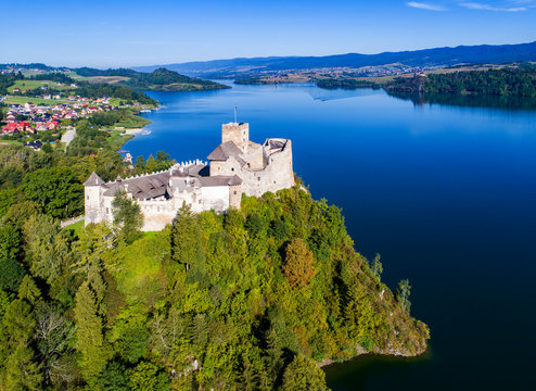 Poland. Medieval Castle in Niedzica, built in 14th century, artificial Czorsztyn Lake and far view of the ruins of Czorsztyn castle, Aerial view in the morning