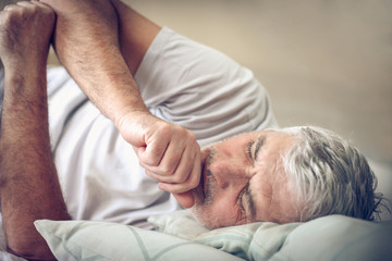 Fototapeta na wymiar Sick senior man in bed.
