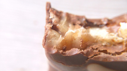 Chocolate bar biting close-up blurred background macro photo