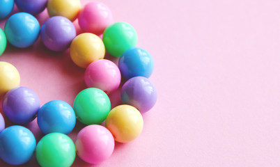 gently spring multi-colored beads on pink background