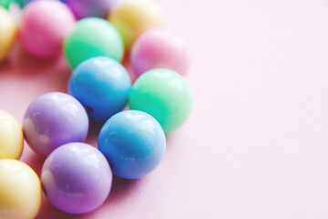 gently spring multi-colored beads on pink background