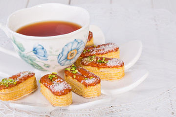 Light Crunchy Puff Layered Pastry Garnished With Pistachios & Coconut Flakes And Cup Of Tea Popular Persian Sweets In Iran Called Zaboon Or Zaban