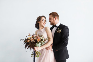 Bride and groom isolated on white wall background
