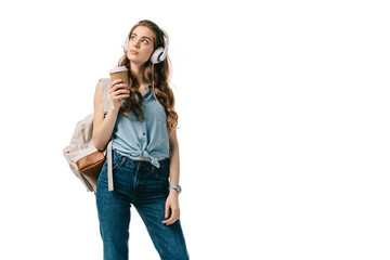 beautiful student holding coffee and listening music isolated on white