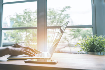 Business and technology concept. Closeup of hand online working with computer at home. Nomad or freelance working anywhere.