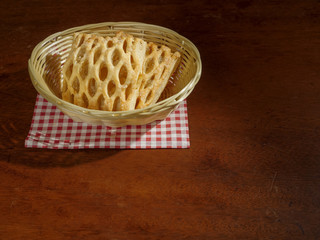 Apple lattice in a basket on a wooden table.