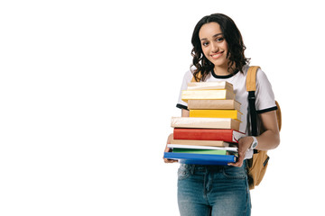 smiling african american teen student holding stack of books isolated on white