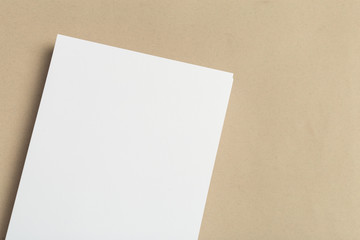 White business card on wooden table. Blank portrait A4.