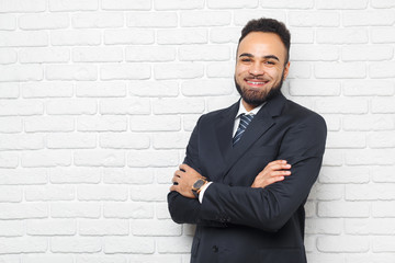 Young fashionable men in a suit against brick wall