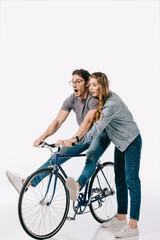 Fototapeta na wymiar girlfriend teaching boyfriend ride bicycle on white
