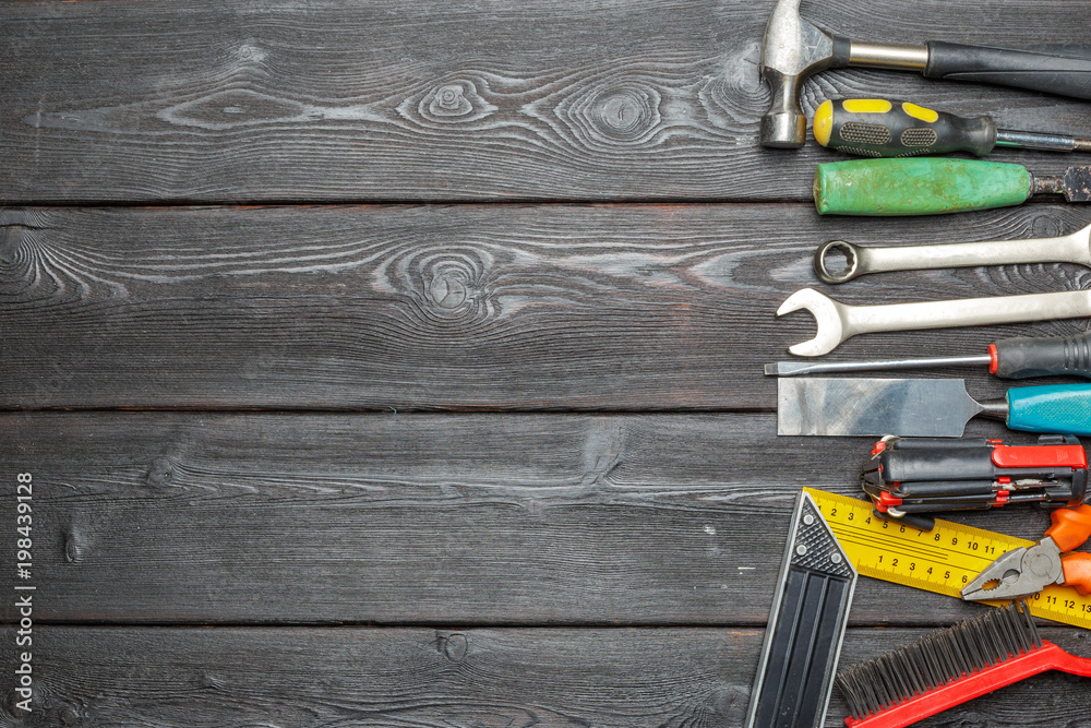 Wall mural Assorted work tools on wooden table