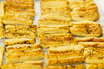 Closeup of a tray with freshly baked cheese crackers with caraway seeds