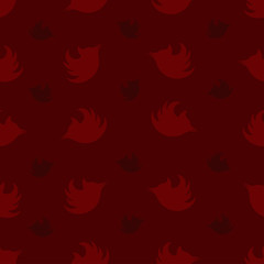Seamless pattern with silhouettes of woodpeckers in burgundy tones