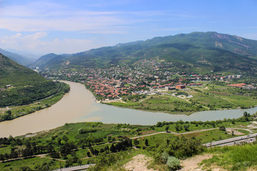 Fototapeta na wymiar Beautiful merge of two rivers: Kura and Aragvi, panoramic view near Mtskheta, Georgia