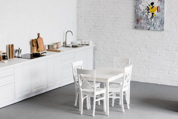 white dining table at modern kitchen with white brick walls