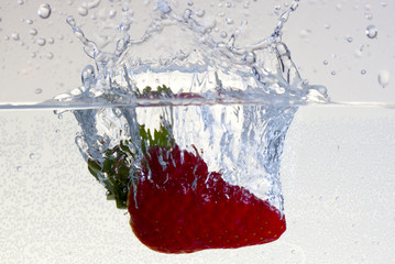 Water splashing on a strawberry