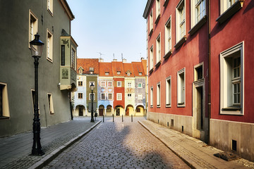 Street to the Merchant houses in the Poznan Old Market Square at sunrise, Poland.