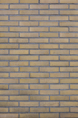 vertical part of brick wall with yellow bricks