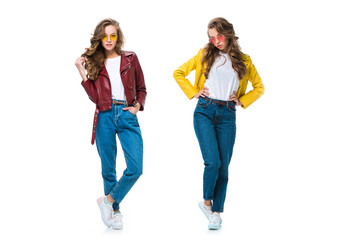 Fototapeta premium attractive stylish twins in leather jackets and sunglasses posing isolated on white