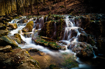 Wasserfall mit Moos auf Steinen im Wald