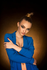 Beautiful young girl in blue jacket with beauty makeup in studio
