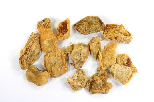Heap of domestic salty fried pork greaves, cvarci, isolated on white.
