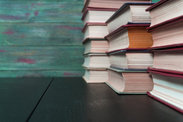 Stack books on wooden background. Back to school with copy space.