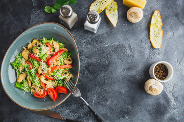 Fresh salad with mushroom, cheese, lettuce and pepper in a plate. Flat lay. Top view
