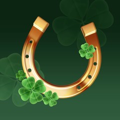 Golden horseshoe with clover on a green background