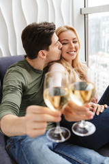 Smiling young loving couple drinking alcohol white wine champagne.