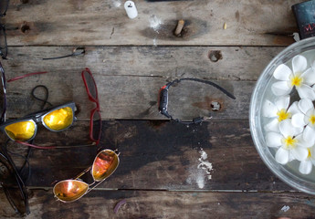 Table with flower and sunglasses