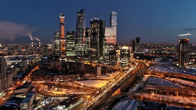 Moscow-city night life timelapse shot. City traffic and night illumination. Skyscrapers with illuminated windows in the middle of traffic junction. 