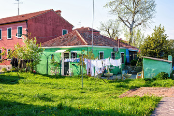 Daylight view to old green painted house with yard