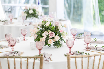 Beautiful table setting with crockery and flowers for a party, wedding reception or other festive...