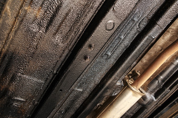 car mechanic cleaning car wheel brake disk from rust corrosion at automobile repair service station