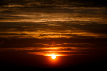 Fototapeta na wymiar amazing sun at dusk clouds. sunset image. beautiful red cloudy sunset in orange sky, dramatic view. fascinating wallpaper. beautiful nature moments, breathtaking scenery. pure beauty