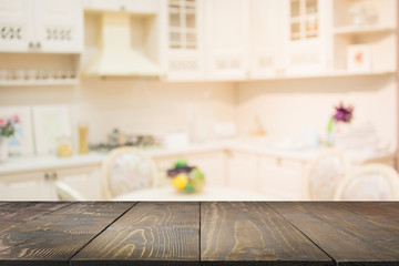 Blurred background. Empty wooden tabletop and defocused modern kitchen.
