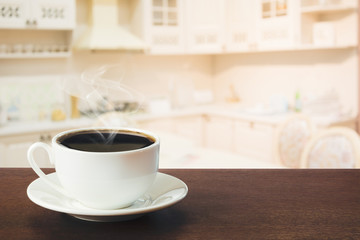 Hot coffee on tabletop in modern kitchen. Close up.